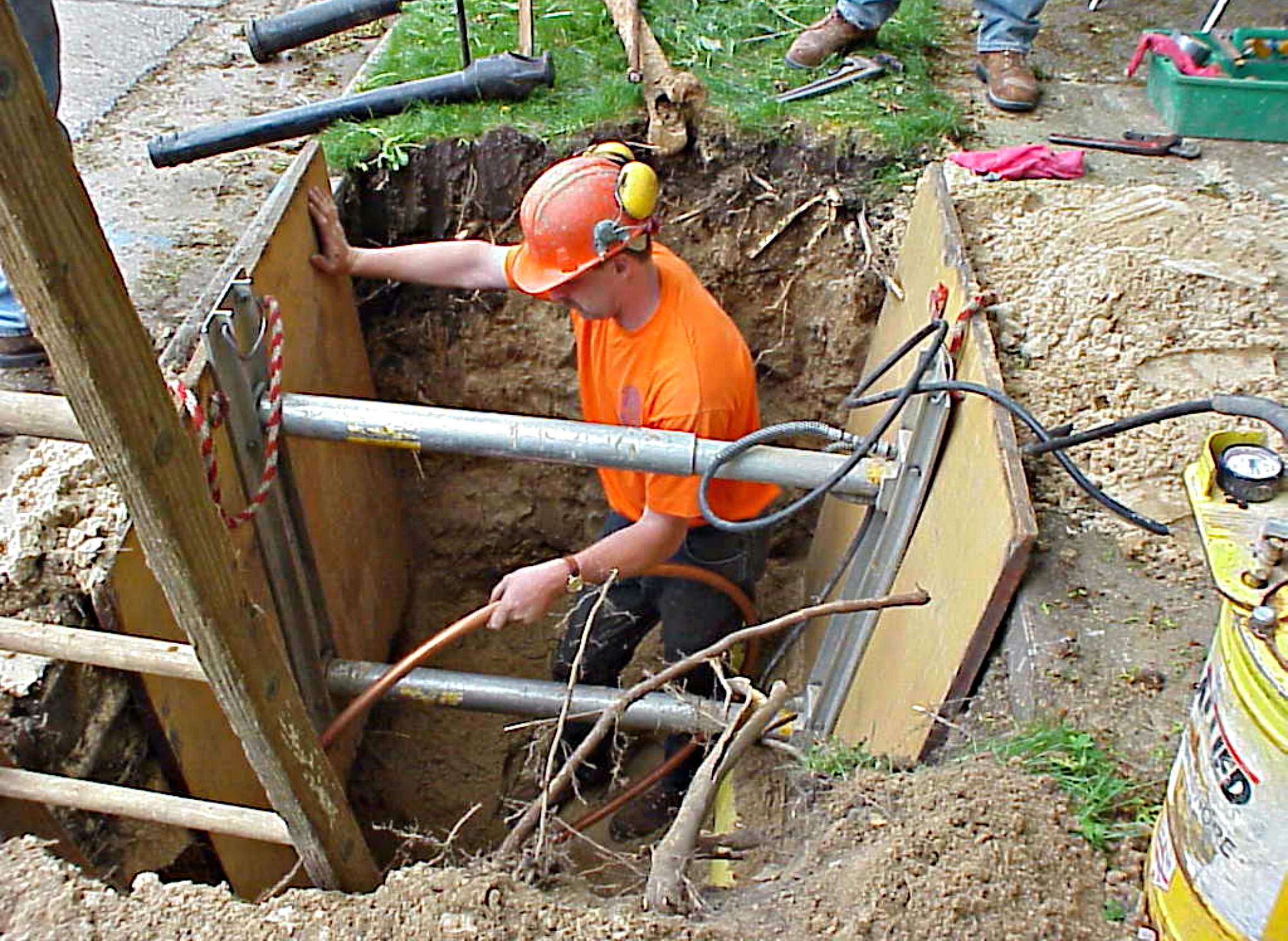 Worker replacing lead pipes in Madison